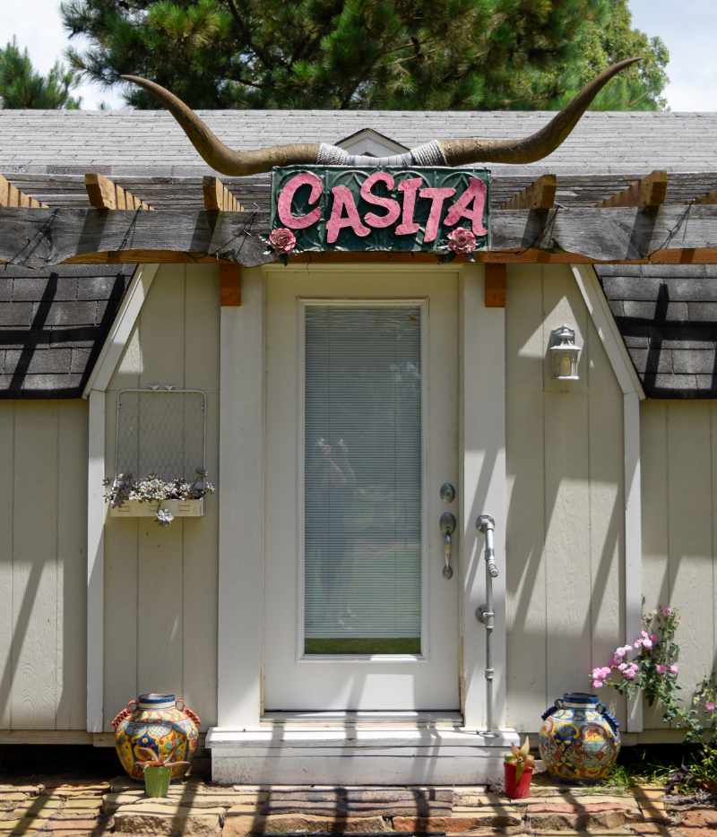Casita sign with longhorns above charming house entrance