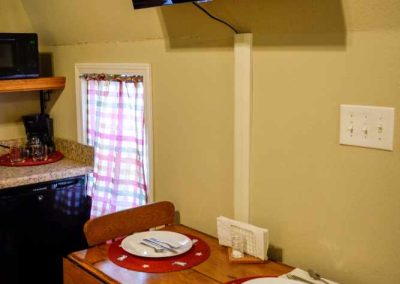 Cozy dining area with mounted TV and wooden table