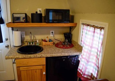 Compact kitchen corner with appliances and granite countertop
