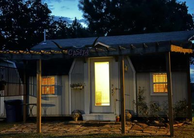 Cozy cottage named 'Casita' illuminated at dusk