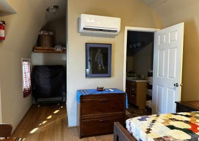Cozy bedroom with air conditioner and open doorway