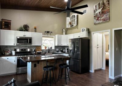 Modern kitchen interior with white cabinets and wooden accents