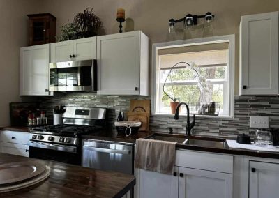 Modern kitchen with white cabinets and stainless appliances