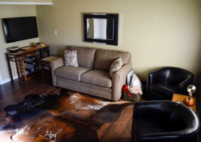 Cozy living room with sofa, chairs, and television