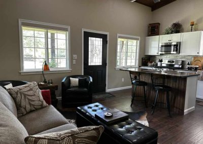 Cozy living room with kitchen and bar stools