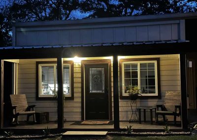 Cozy house exterior at twilight with glowing porch light