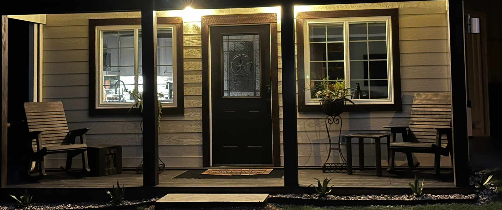Cozy home exterior at night with illuminated windows