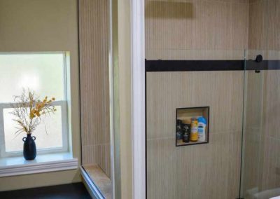 Modern bathroom interior with glass shower and towels