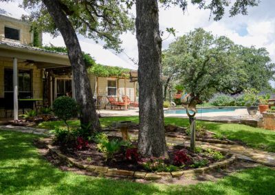 Rustic home with garden, pool, and lounging chairs