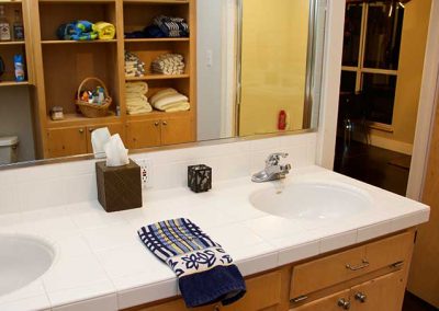 Spacious bathroom with dual sinks and mirrored cabinet