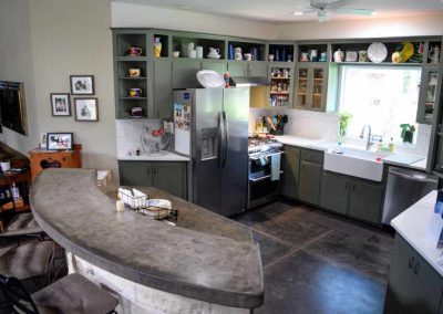 Spacious kitchen with modern appliances and curved countertop
