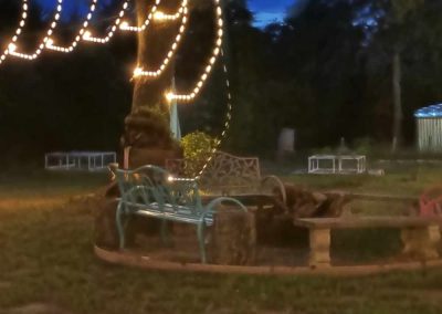 Outdoor evening scene with string lights and garden chairs