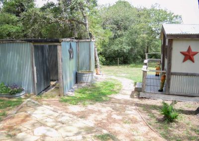 Rustic sheds with star decorations in wooded area