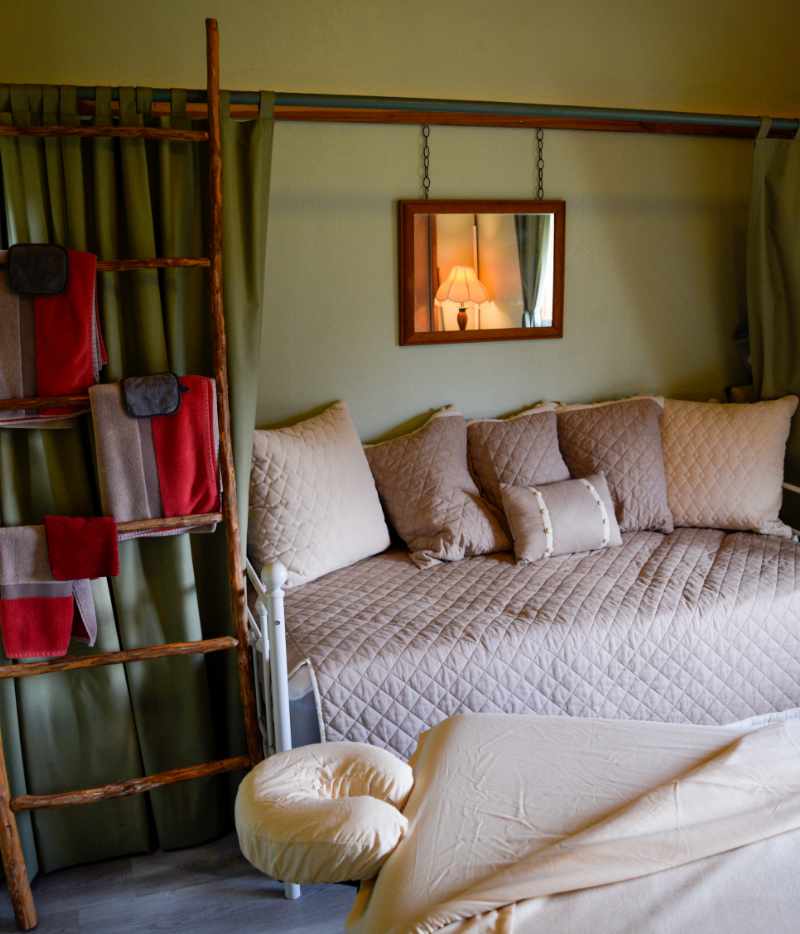 Cozy bedroom with quilted bed and decorative wooden ladder
